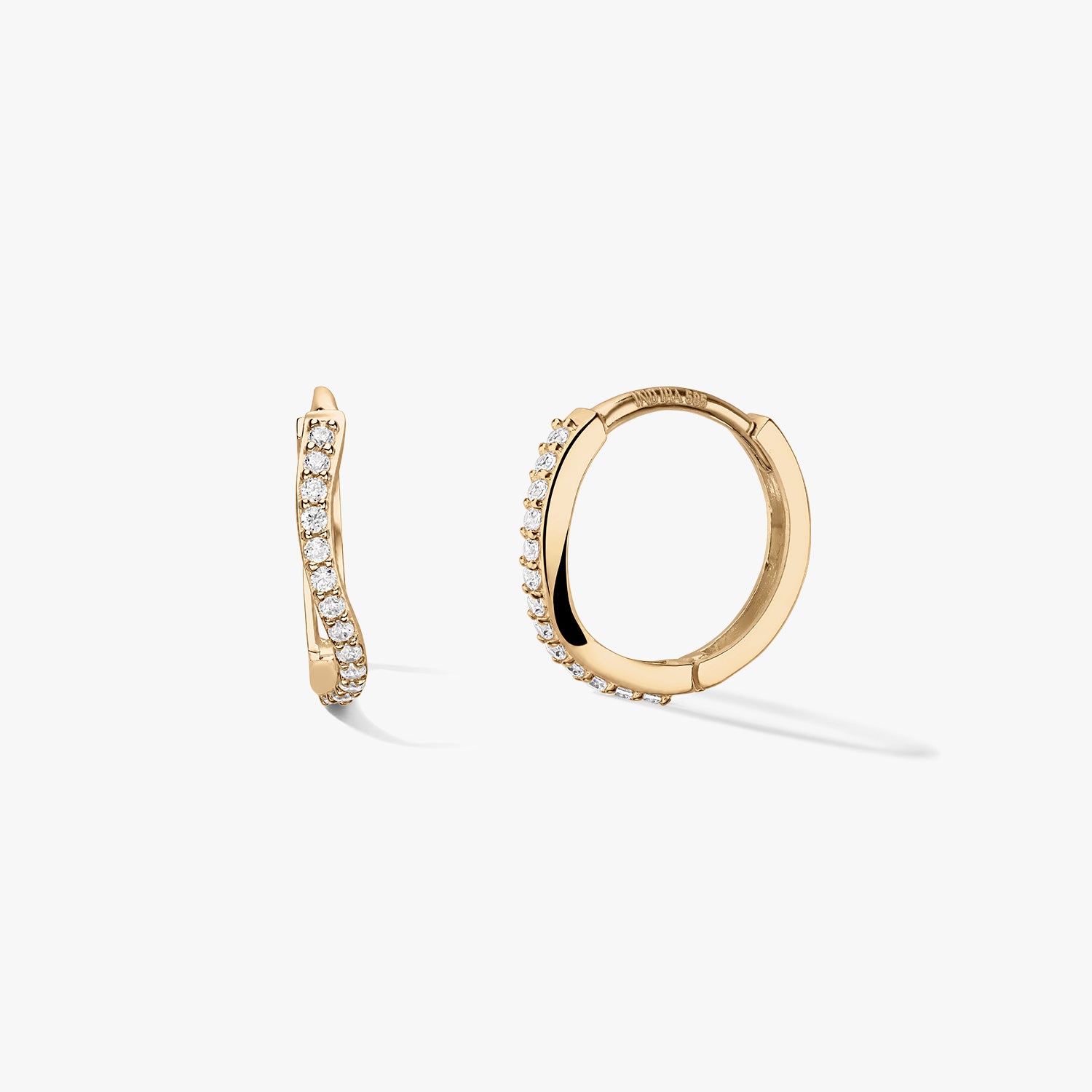 Coppia di orecchini a cerchio huggie in oro giallo 14k con una fila pavé ondulata di zirconi bianchi, su sfondo bianco pulito: una vista laterale e un cerchio aperto per mostrare la chiusura.