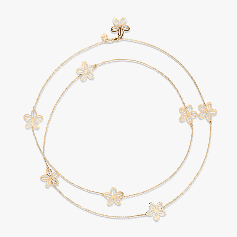 Collana d'oro con motivi floreali su sfondo bianco.
