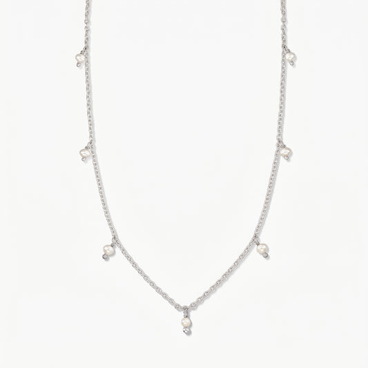 Collana in argento Indira Margot con piccole gocce di perla naturale, fotografata su uno sfondo bianco pulito.