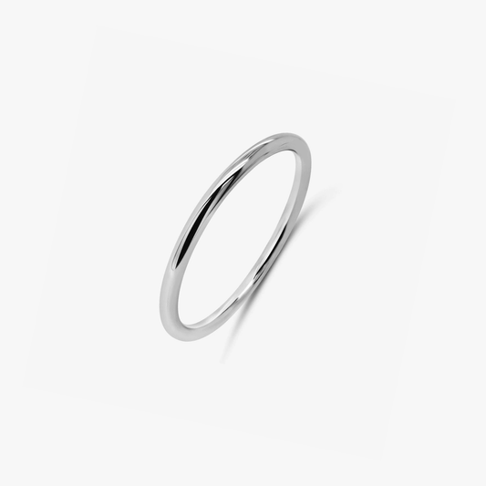 Un anello minimalista in argento fotografato su sfondo bianco.